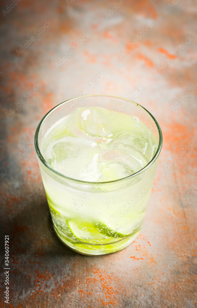 Rum based cocktail caipirinha (variation of cuba libre) on the rustic background. Selective focus. Shallow depth of field.
