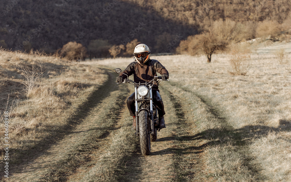 Horizontal view. Motorcyclist on desert, dry grass off road, extreme sport, active lifestyle, adventure touring concept, outdoor. Horizontal view. Motorcyclist on desert, dry grass off road, extreme sport, active lifestyle, adventure touring concept, outdoor.