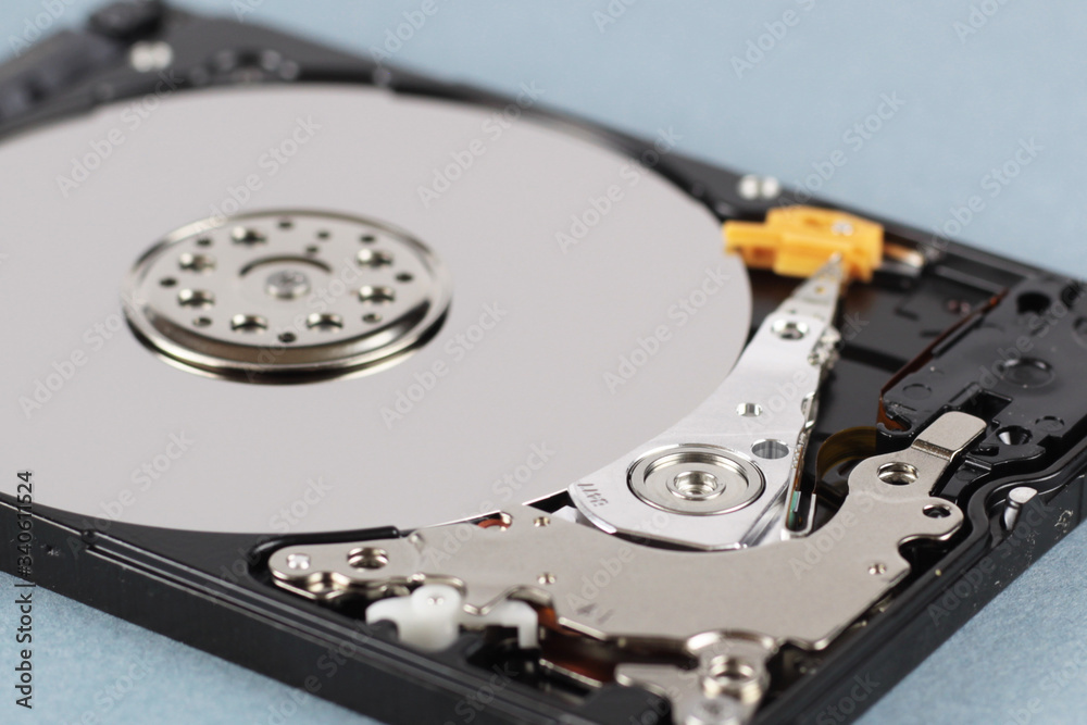 Elements of the inside of a computer hard drive. Side view. Blue background. Elements of the inside of a computer hard drive. Side view. Blue background.