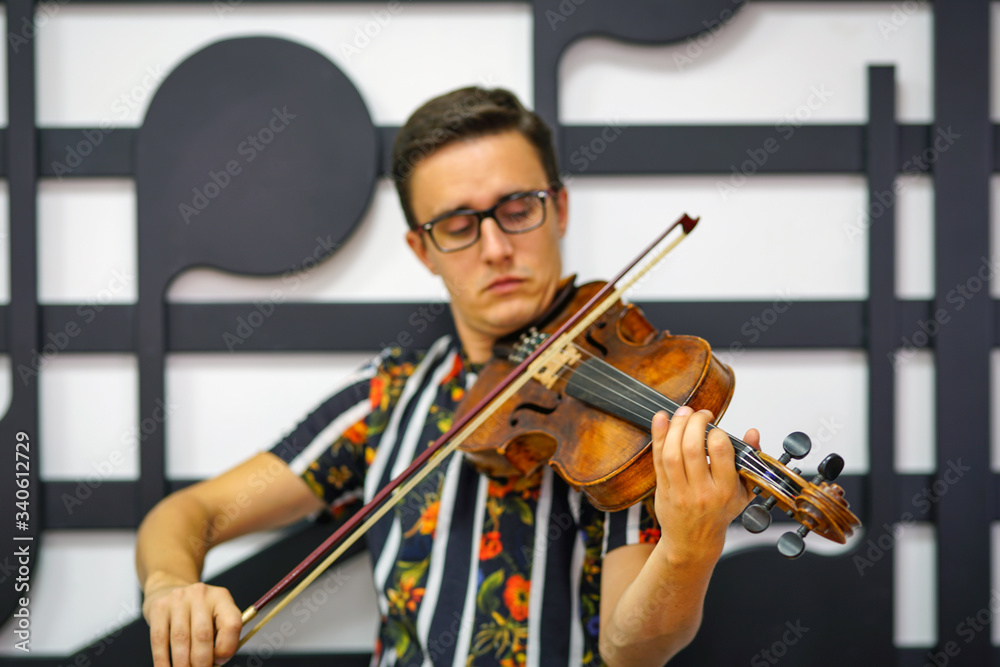 Young musician playing the violin, Close Up, Playing his handmade violin with great success Young musician playing the violin, Close Up, Playing his handmade violin with great success