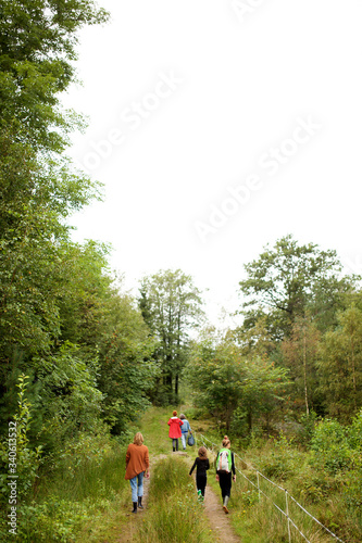 family walking on path in rural area