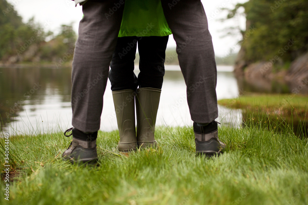 portrait from behind girl and woman standing by lake