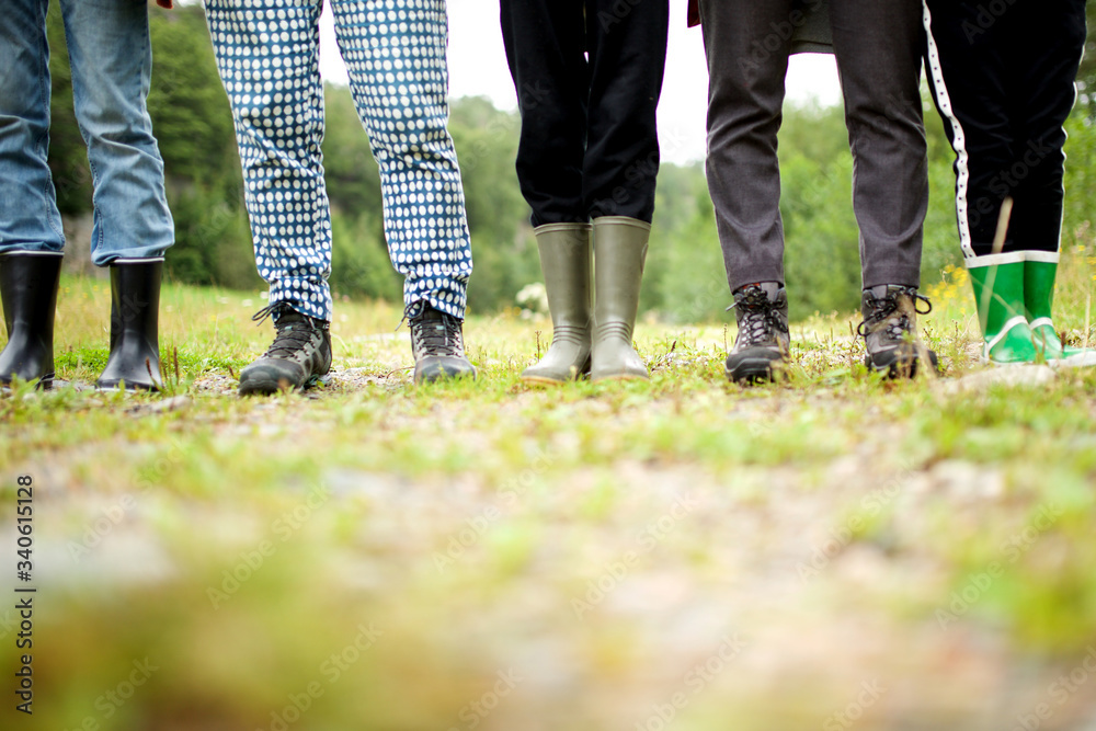 Low angle people standing with hiking boots Low angle people standing with hiking boots