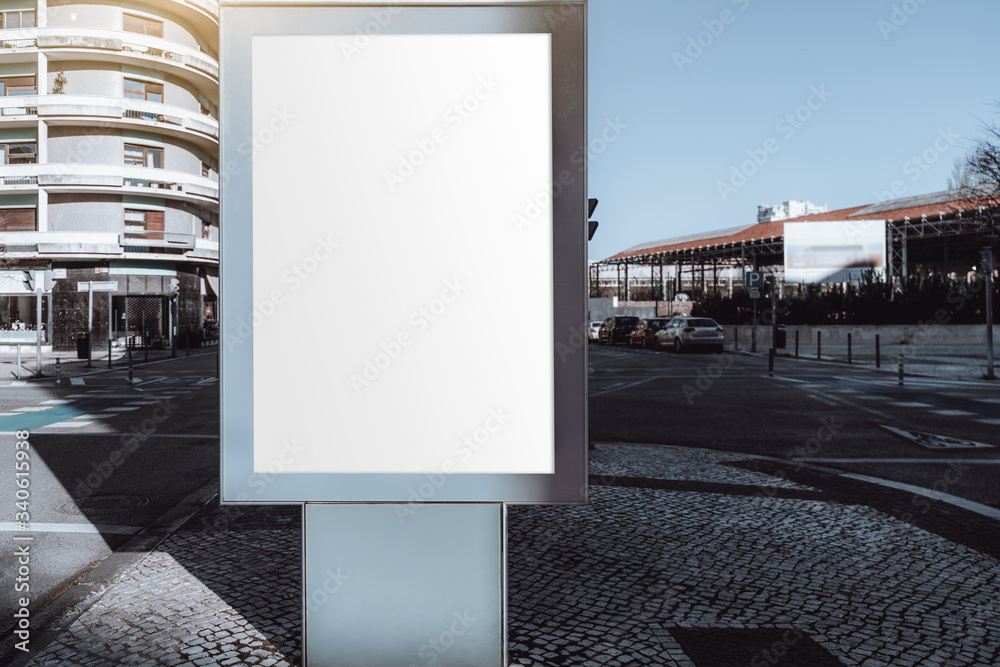 Mockup of an empty ad billboard in urban settings near a road junction; a blank vertical street banner template on paving-stone of the sidewalk; an outdoor poster placeholder mock-up next to the road Mockup of an empty ad billboard in urban settings near a road junction; a blank vertical street banner template on paving-stone of the sidewalk; an outdoor poster placeholder mock-up next to the road