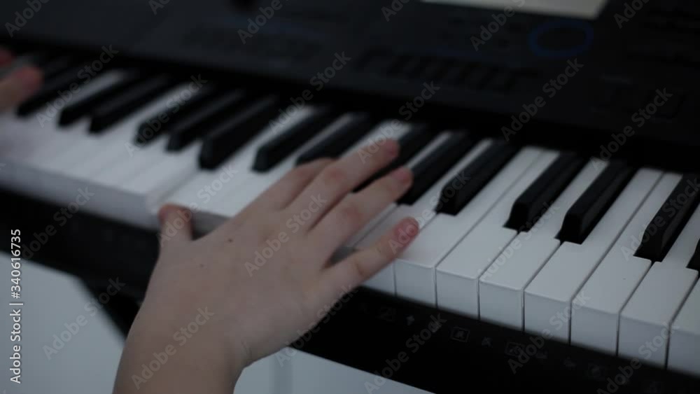 men's hands play on a black synthesizer. men's hands play on a black synthesizer.