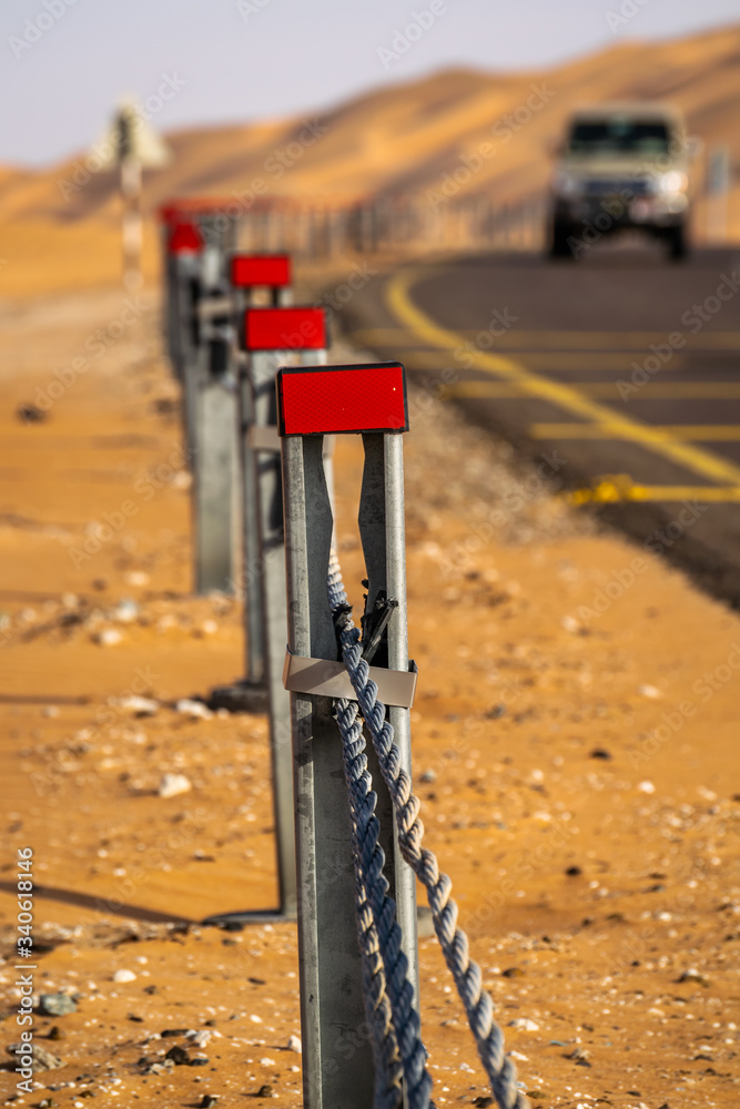 a blurred selective focused view of road dividers reflection from Liwa desert Abu Dhabi