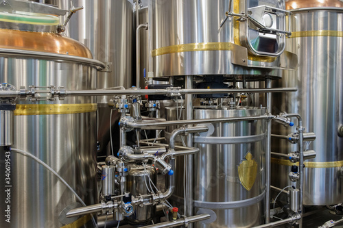 Stainless steel brewing tanks and equipment, iron reservoirs and pipes in modern beer factory