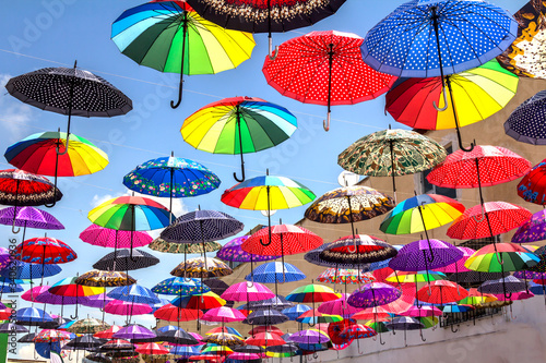 colorful umbrella roof between buildings in a shopping center