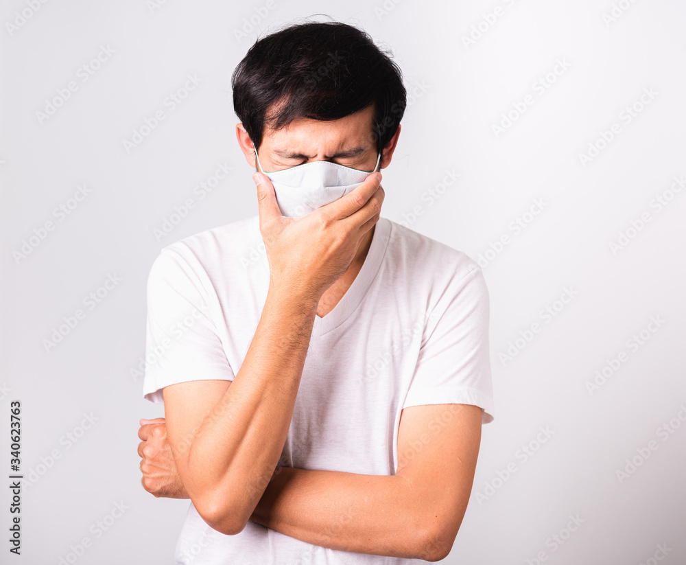 Man wearing surgical hygienic protective cloth face mask against coronavirus he sneeze Man wearing surgical hygienic protective cloth face mask against coronavirus he sneeze