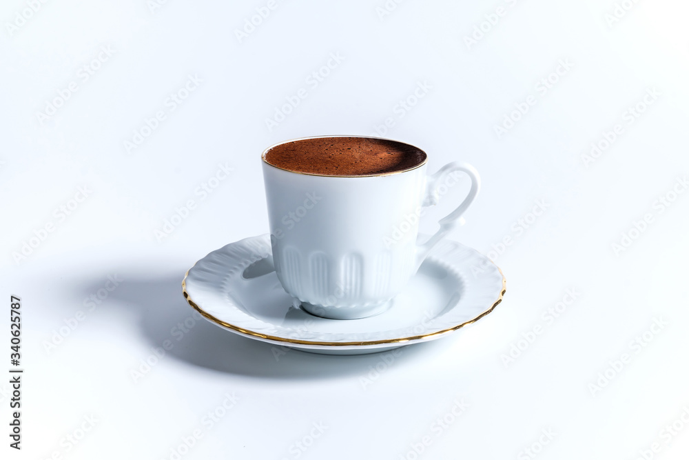 A cup of Turkish coffee in traditional white porcelain Turkish coffee cup