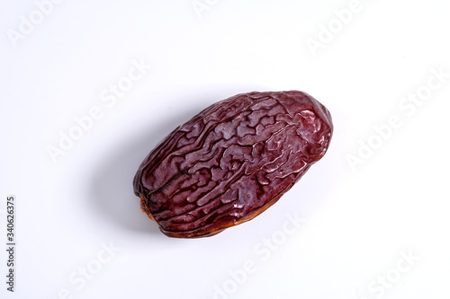 A dried date fruit isolated on white, top view photo of a date fruit 