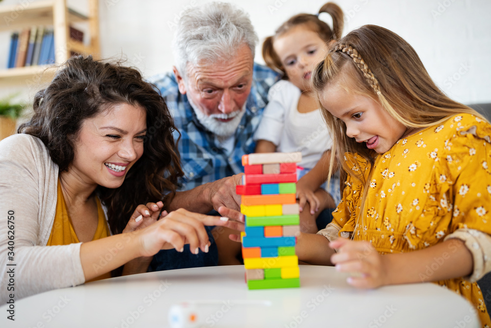 Happy family having fun time at home. Grandparent playing with children Happy family having fun time at home. Grandparent playing with children