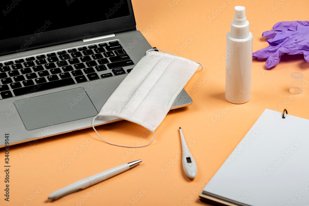 Things necessary for Online work and education in conditions of quarantine on orange background table. Things necessary for Online work and education in conditions of quarantine on orange background table.
