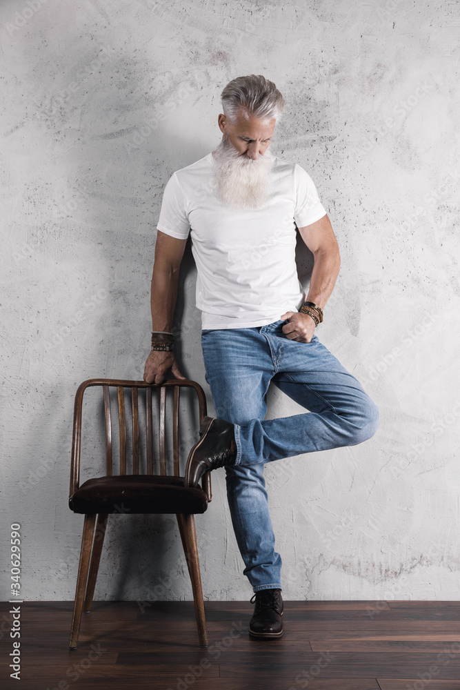 Handsome bearded senior man posing in studio