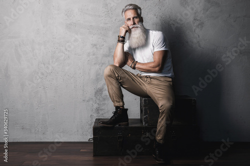 Handsome bearded senior man posing in studio