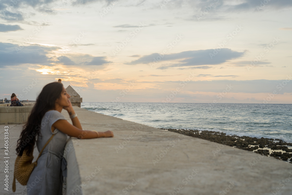 Young indian woman pensive in front of sea Young indian woman pensive in front of sea