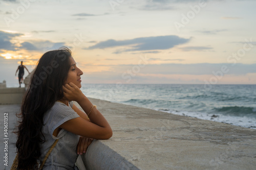 Young indian woman pensive in front of sea