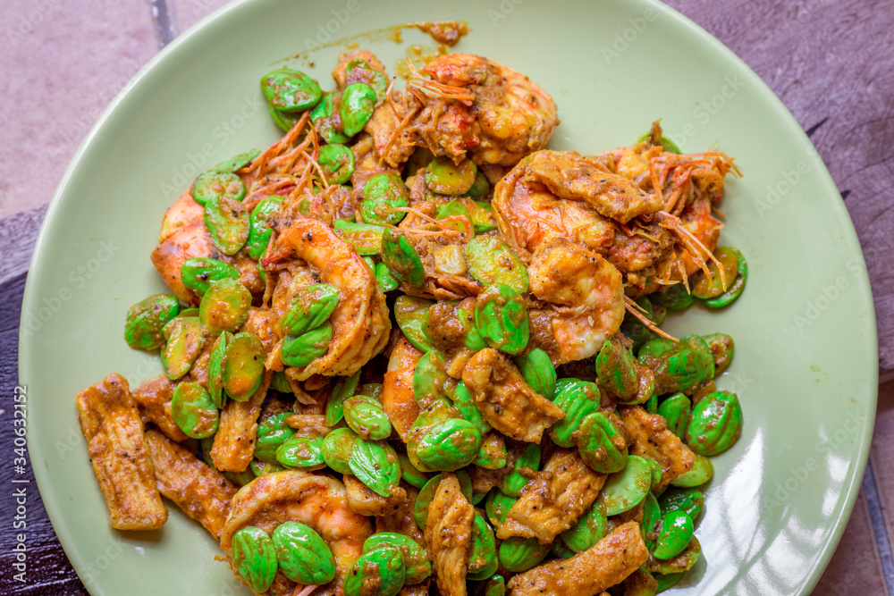 blurred background view of the spicy southern Thai food(stir-fried spicy Sato with fresh prawns),which has a mixture of colorful spices catching the customers, a popular menu eaten with steamed rice blurred background view of the spicy southern Thai food(stir-fried spicy Sato with fresh prawns),which has a mixture of colorful spices catching the customers, a popular menu eaten with steamed rice