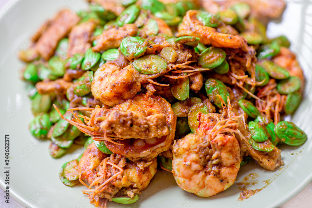 blurred background view of the spicy southern Thai food(stir-fried spicy Sato with fresh prawns),which has a mixture of colorful spices catching the customers, a popular menu eaten with steamed rice blurred background view of the spicy southern Thai food(stir-fried spicy Sato with fresh prawns),which has a mixture of colorful spices catching the customers, a popular menu eaten with steamed rice