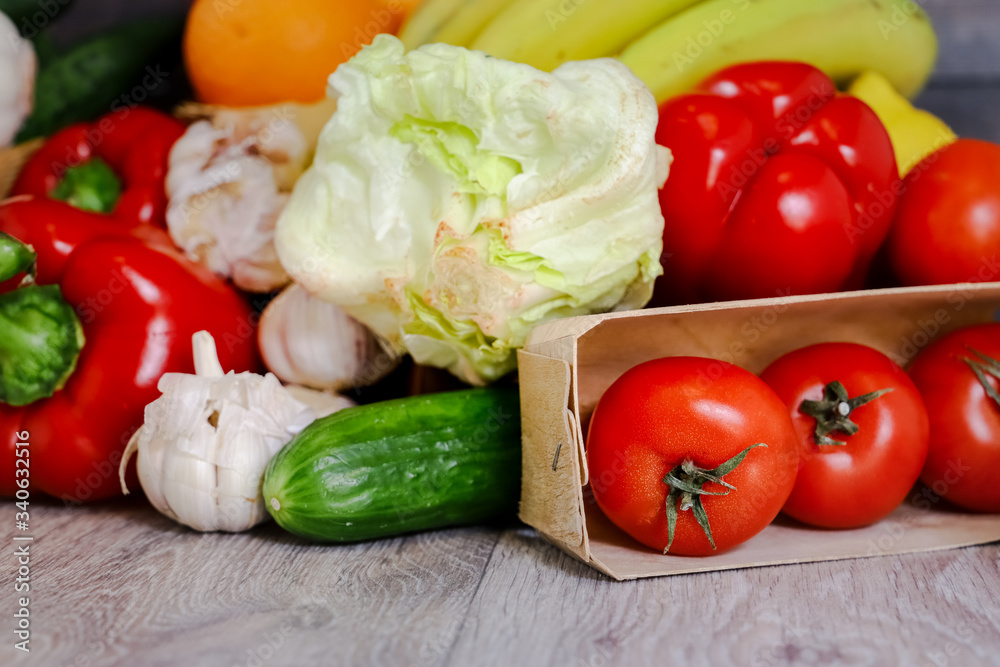 Against the background of a light countertop, tomatoes, cucumber, red pepper, garlic, iceberg salad. Against the background of a light countertop, tomatoes, cucumber, red pepper, garlic, iceberg salad.