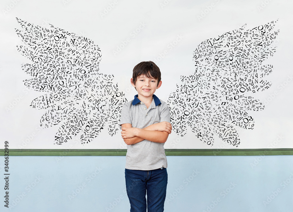Pupils in front of blackboard with wings of letters Stock Photo | Adobe