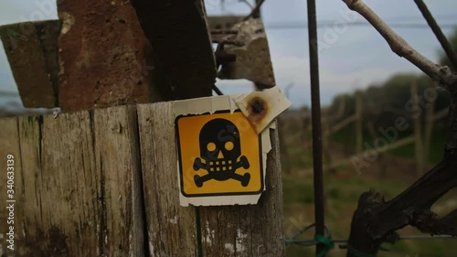Danger of death sign on an old and ruined wooden stand in the countryside, 4k slow motion video.