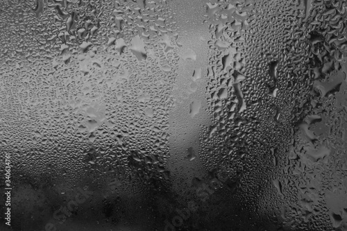Monochrome drops of water. Raindrops close up. Raindrops on the glass.