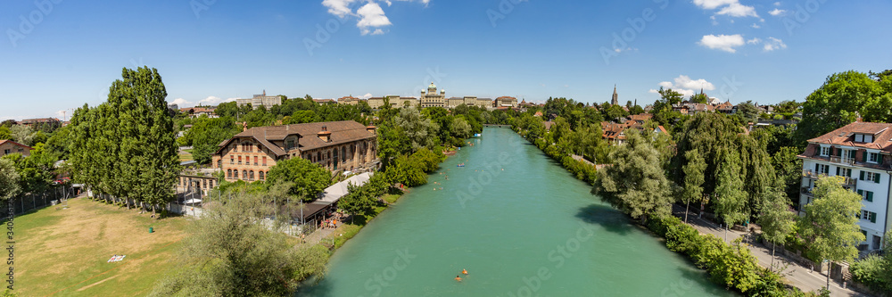 Bern, Switzerland - July 30, 2019: Aerial view of Aar from the Monbijoubrucke Bridge. Brige over the Aare river. Bern Switzerland. The Parliament Building on the background. Super wide angle panorama