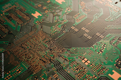 A close-up of black Green coloured Printed circuit board (PCB) with no component mounted (copper exposed) photo