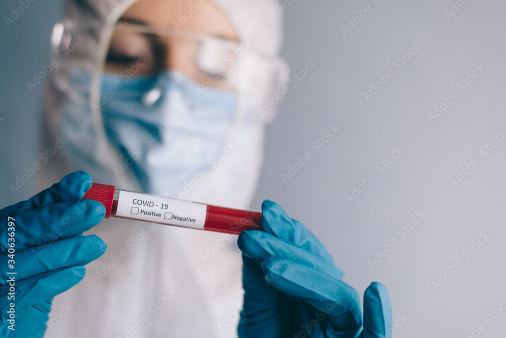 Coronavirus testing. A nurse is holding a test tube with a patients blood sample. Coronavirus testing. A nurse is holding a test tube with a patients blood sample.