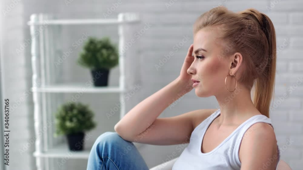 Beautiful young girl with trendy hairstyle relaxing at modern white room. 4k Dragon RED camera Beautiful young girl with trendy hairstyle relaxing at modern white room. 4k Dragon RED camera