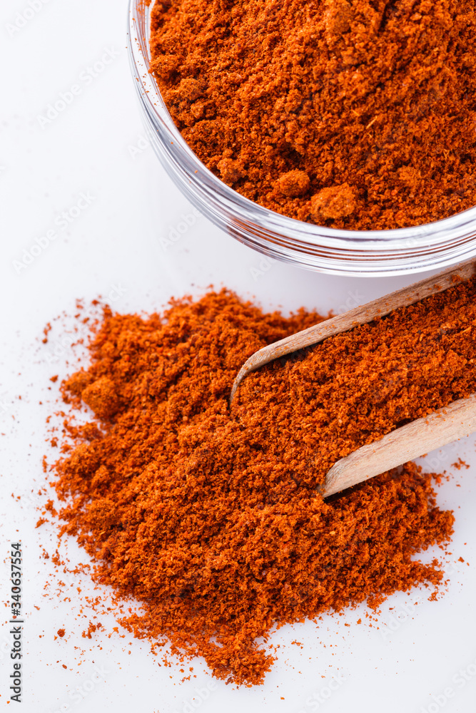 aromatic spicy chili powder on a white background aromatic spicy chili powder on a white background