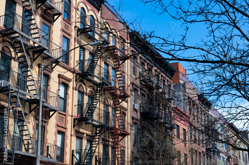 Row of Colorful Old Buildings with Fire Escapes in Harlem of New York City