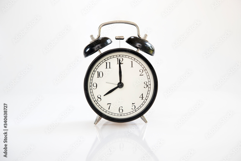 Black retro alarm clock isolated on white background Black retro alarm clock isolated on white background