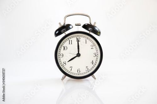Black retro alarm clock isolated on white background