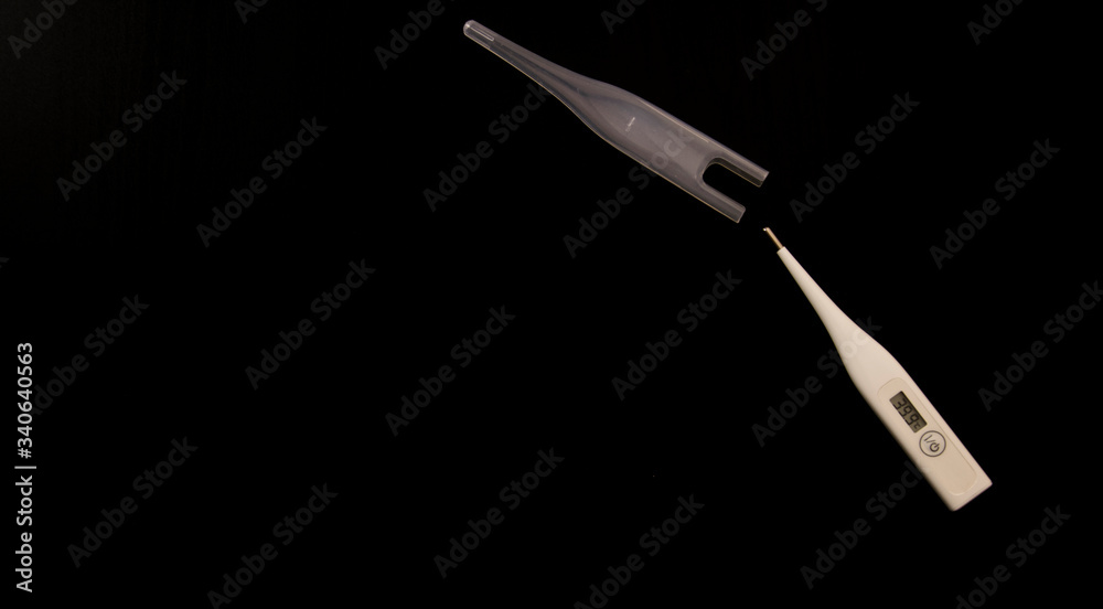 white thermometer with high temperature on a black background isolate white thermometer with high temperature on a black background isolate