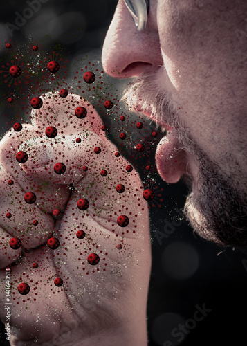 Man coughing into closed fist with virus particles flying out of mouth
