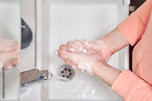 Woman washing hands in bath
