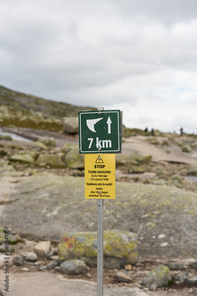 Hiking tourist rout sign to Trolltunga rock with distance, Norway