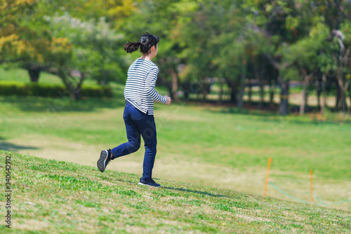 Japanese young woman running at park in spring
