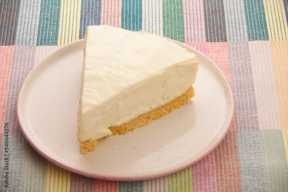 classic cheesecake on white plate on  wooden table