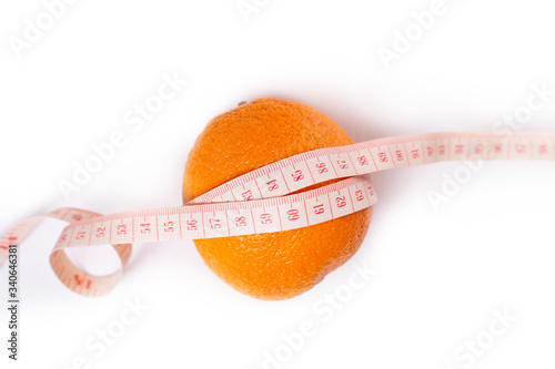 oranges and measuring tape on white background. Weight loss and slimming treatment concept. Copy space. Slimming and diet eating concept