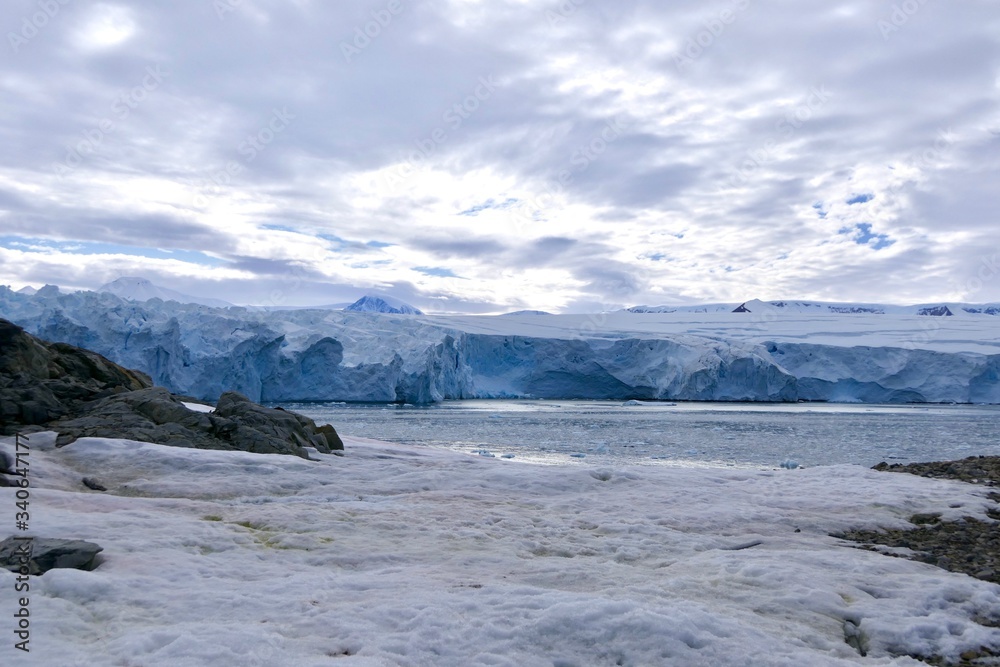 Glacier front with stone and snow landscape in Antarctica, Stonington Island