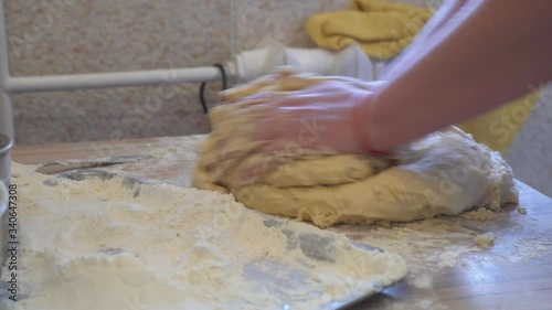 woman's hands close up kneading dough
