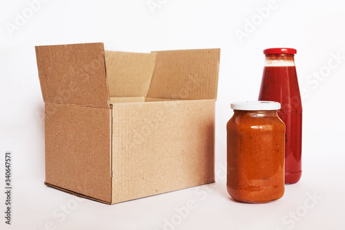 Donation box with homemade canned food on white background. Cardboard box with donation food. Food delivery concept. Place for text