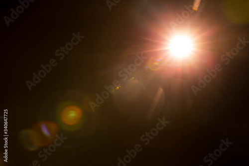 Abstract Natural Sun flare on the black background. photo