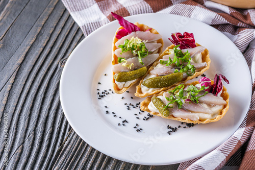 delicious snack tartlets on rustic wooden background