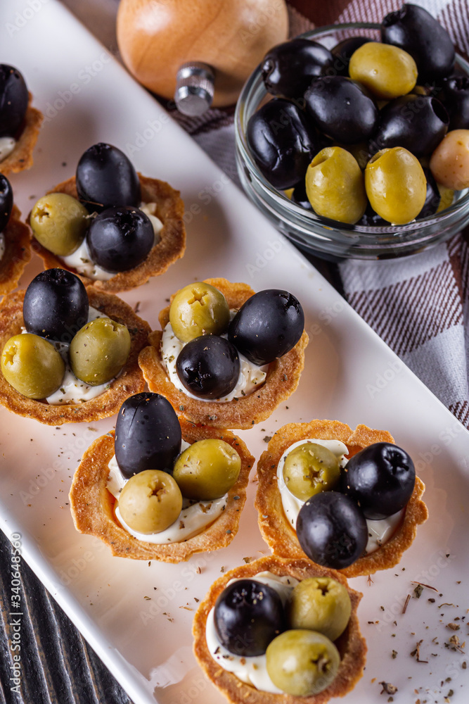 delicious snack tartlets on rustic wooden background delicious snack tartlets on rustic wooden background
