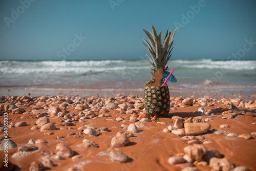Ripe pineapples on the sandy tropical beach with sky in sunset. Leisure in summer and Summer vacation concept. vintage color tone.