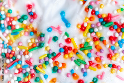 White icing with colored sprinkles, top view
